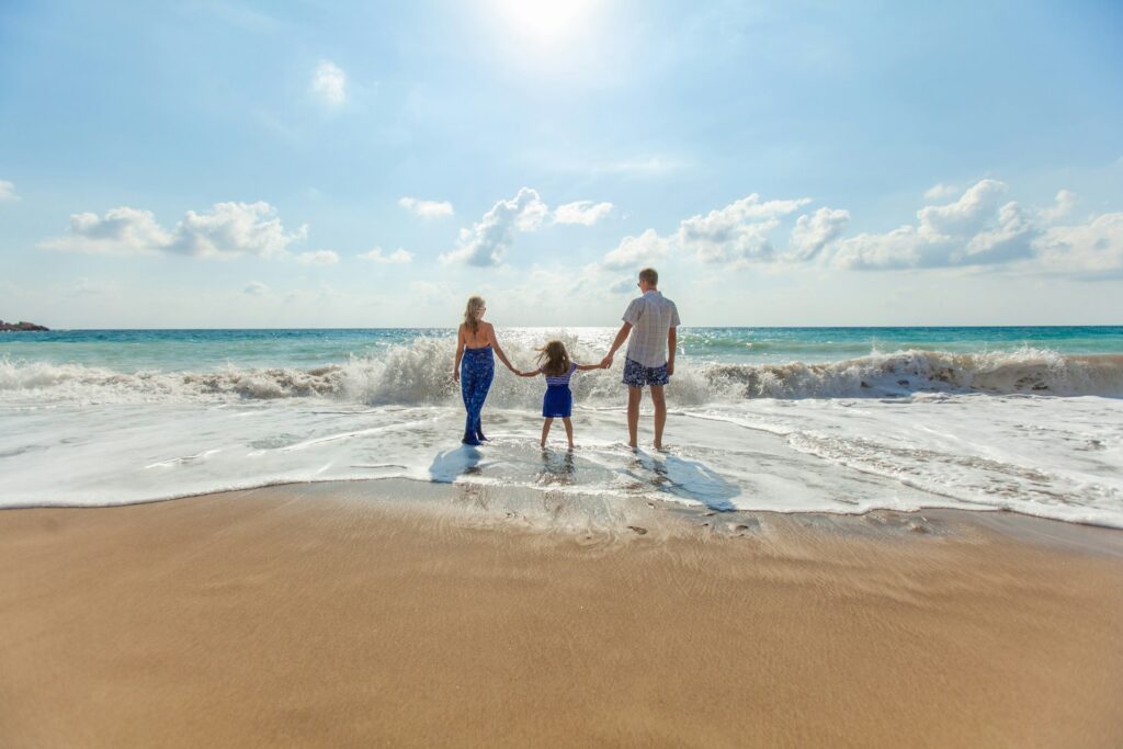 Family on beach - Photo by Natalya Zaritskaya on Unsplash